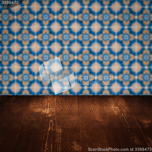 Image of Wood table top and blur vintage ceramic tile pattern wall