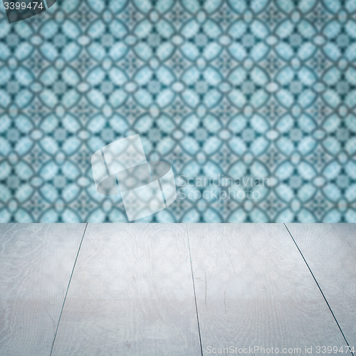 Image of Wood table top and blur vintage ceramic tile pattern wall