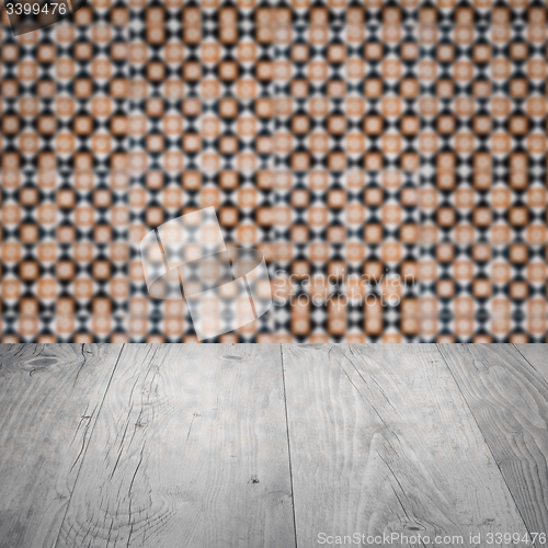Image of Wood table top and blur vintage ceramic tile pattern wall