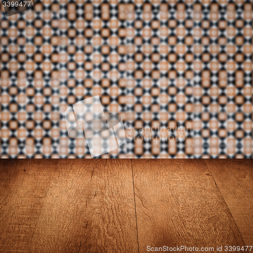 Image of Wood table top and blur vintage ceramic tile pattern wall