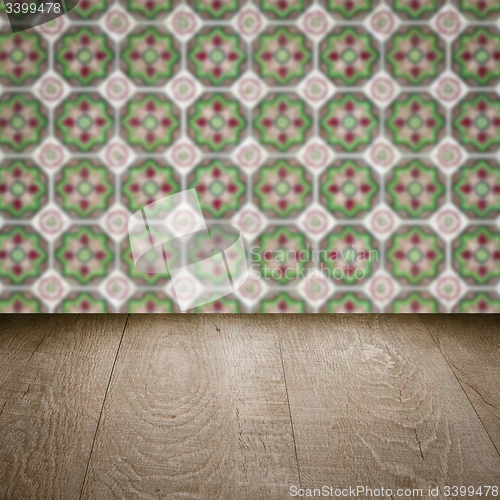 Image of Wood table top and blur vintage ceramic tile pattern wall