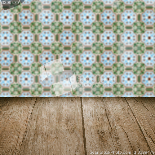 Image of Wood table top and blur vintage ceramic tile pattern wall