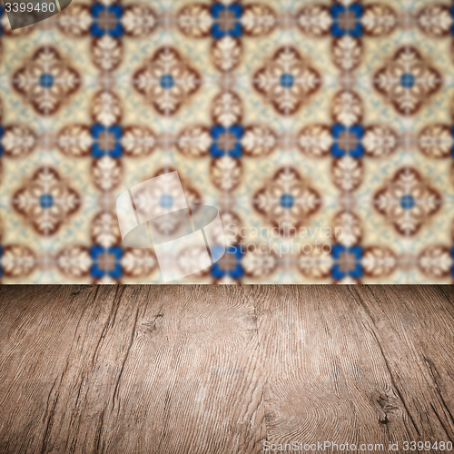 Image of Wood table top and blur vintage ceramic tile pattern wall