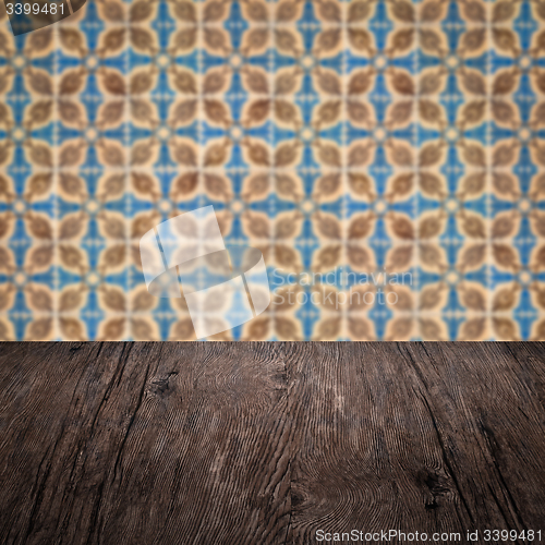 Image of Wood table top and blur vintage ceramic tile pattern wall