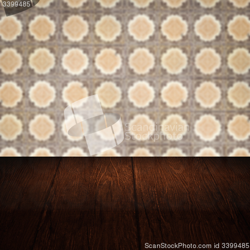 Image of Wood table top and blur vintage ceramic tile pattern wall