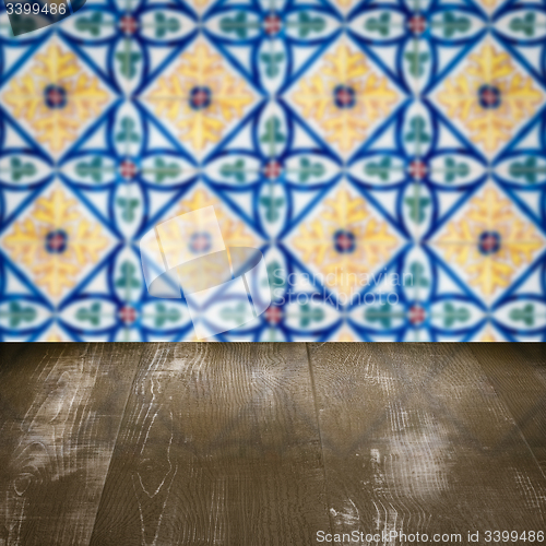 Image of Wood table top and blur vintage ceramic tile pattern wall