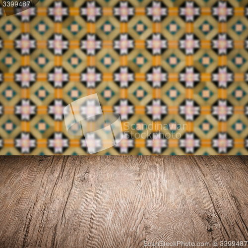 Image of Wood table top and blur vintage ceramic tile pattern wall