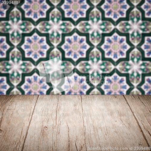 Image of Wood table top and blur vintage ceramic tile pattern wall