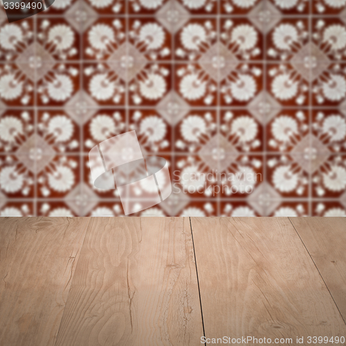 Image of Wood table top and blur vintage ceramic tile pattern wall