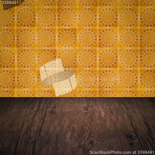 Image of Wood table top and blur vintage ceramic tile pattern wall