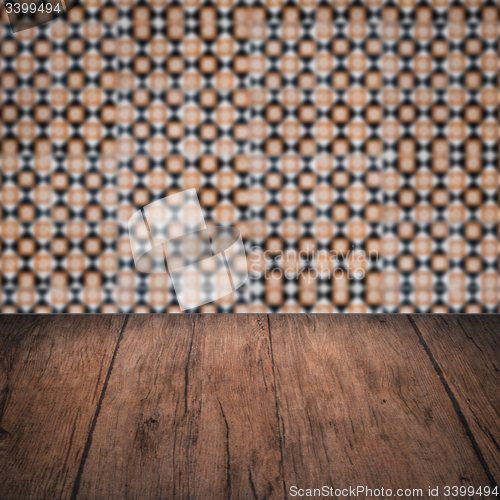 Image of Wood table top and blur vintage ceramic tile pattern wall