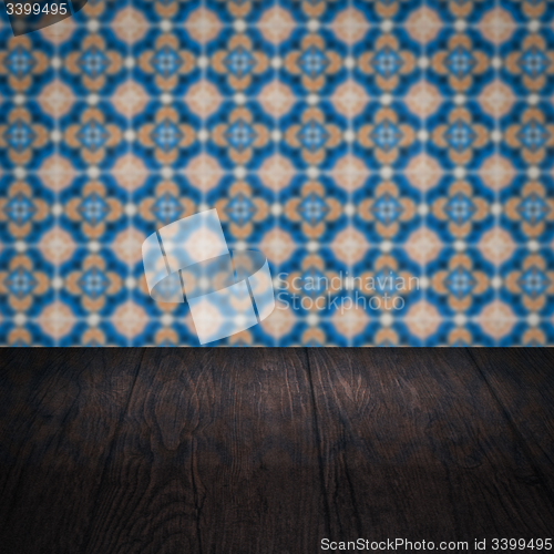 Image of Wood table top and blur vintage ceramic tile pattern wall
