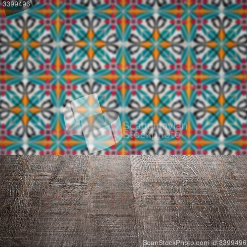 Image of Wood table top and blur vintage ceramic tile pattern wall