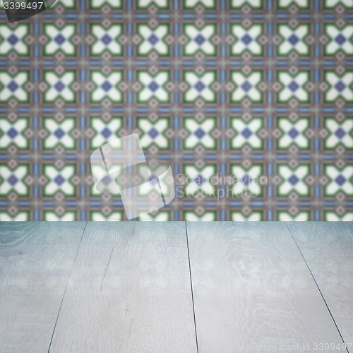 Image of Wood table top and blur vintage ceramic tile pattern wall