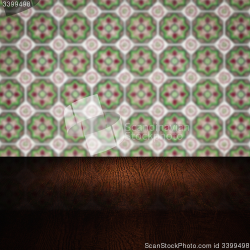 Image of Wood table top and blur vintage ceramic tile pattern wall