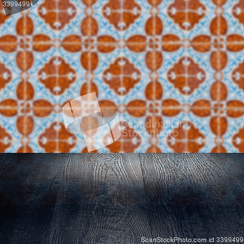 Image of Wood table top and blur vintage ceramic tile pattern wall