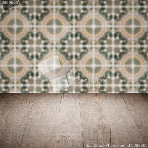 Image of Wood table top and blur vintage ceramic tile pattern wall