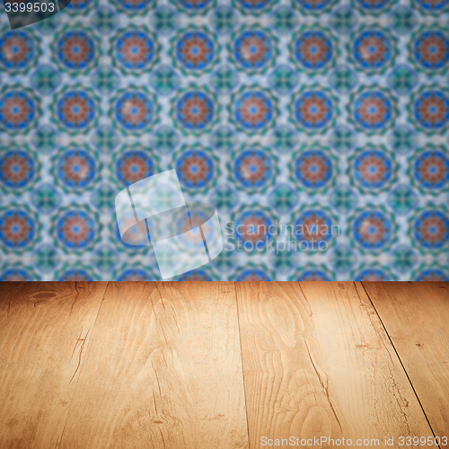 Image of Wood table top and blur vintage ceramic tile pattern wall