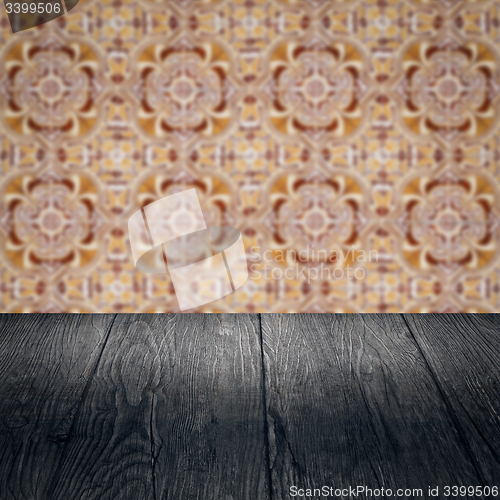 Image of Wood table top and blur vintage ceramic tile pattern wall