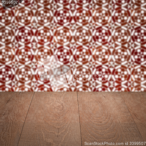 Image of Wood table top and blur vintage ceramic tile pattern wall