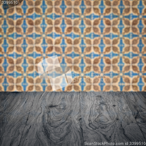 Image of Wood table top and blur vintage ceramic tile pattern wall