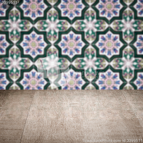 Image of Wood table top and blur vintage ceramic tile pattern wall