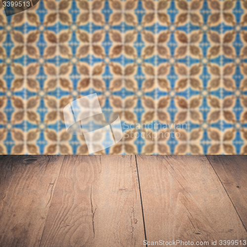 Image of Wood table top and blur vintage ceramic tile pattern wall