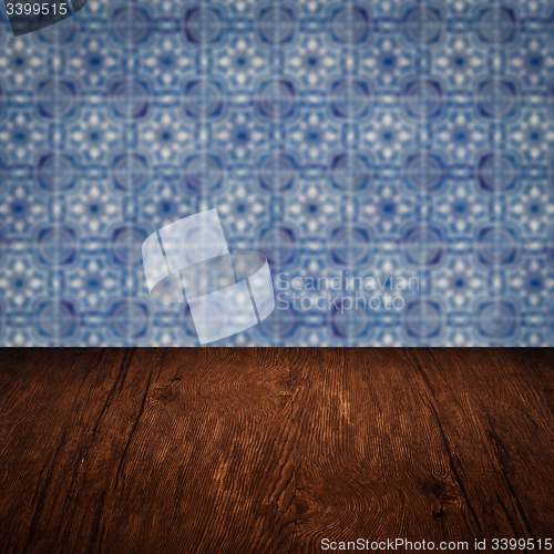 Image of Wood table top and blur vintage ceramic tile pattern wall