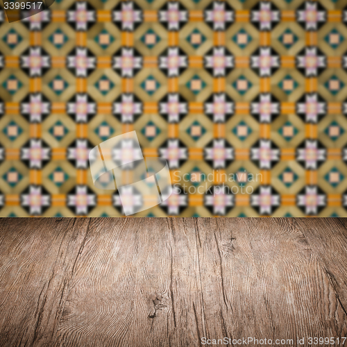 Image of Wood table top and blur vintage ceramic tile pattern wall
