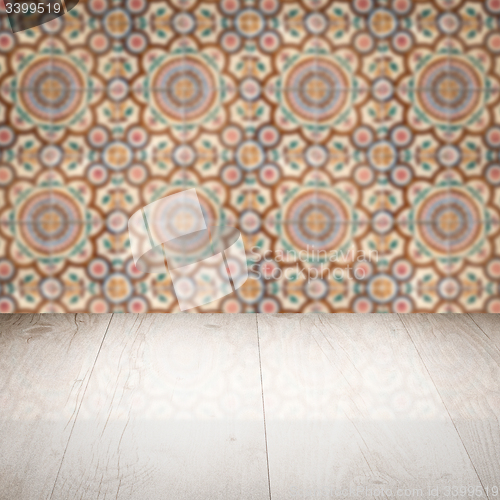 Image of Wood table top and blur vintage ceramic tile pattern wall