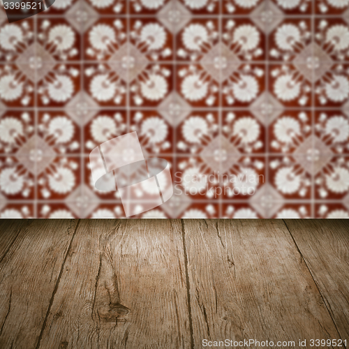 Image of Wood table top and blur vintage ceramic tile pattern wall