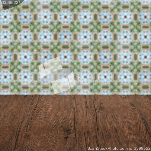 Image of Wood table top and blur vintage ceramic tile pattern wall