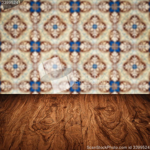 Image of Wood table top and blur vintage ceramic tile pattern wall