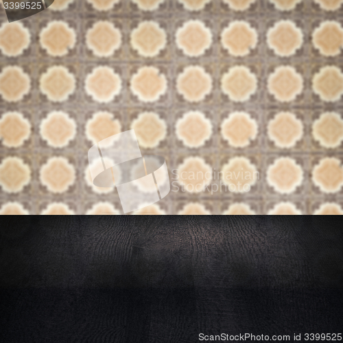 Image of Wood table top and blur vintage ceramic tile pattern wall