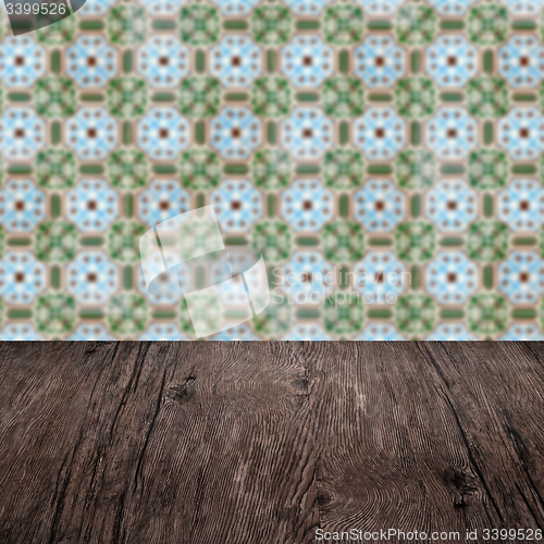 Image of Wood table top and blur vintage ceramic tile pattern wall