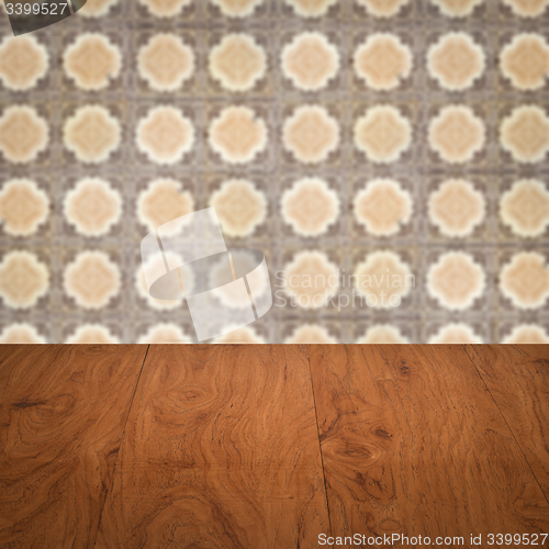 Image of Wood table top and blur vintage ceramic tile pattern wall