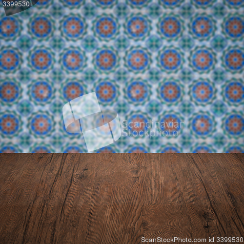 Image of Wood table top and blur vintage ceramic tile pattern wall