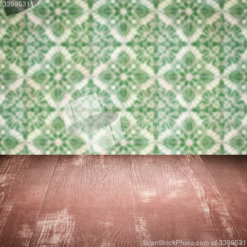 Image of Wood table top and blur vintage ceramic tile pattern wall