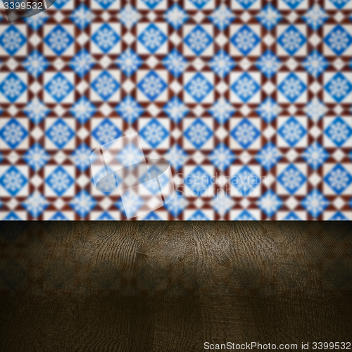 Image of Wood table top and blur vintage ceramic tile pattern wall