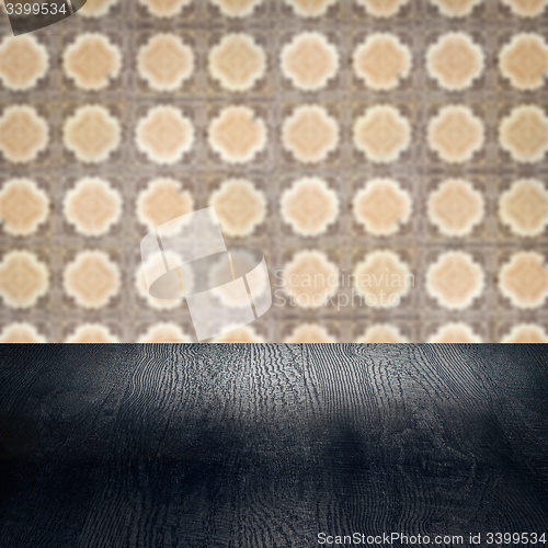 Image of Wood table top and blur vintage ceramic tile pattern wall