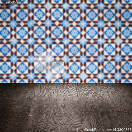 Image of Wood table top and blur vintage ceramic tile pattern wall