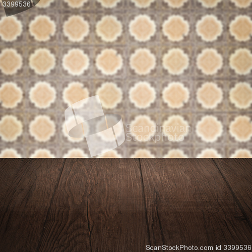 Image of Wood table top and blur vintage ceramic tile pattern wall