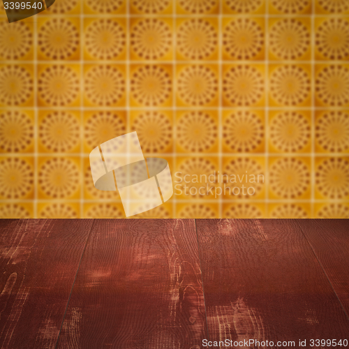 Image of Wood table top and blur vintage ceramic tile pattern wall