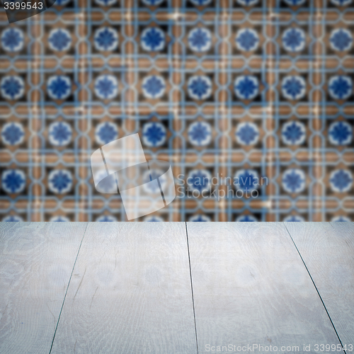 Image of Wood table top and blur vintage ceramic tile pattern wall