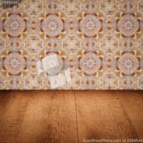 Image of Wood table top and blur vintage ceramic tile pattern wall