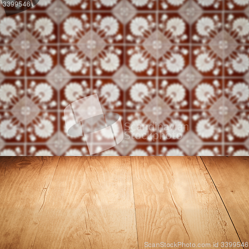 Image of Wood table top and blur vintage ceramic tile pattern wall