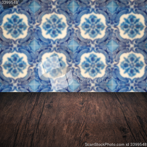 Image of Wood table top and blur vintage ceramic tile pattern wall