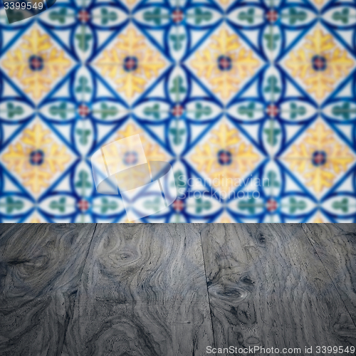 Image of Wood table top and blur vintage ceramic tile pattern wall