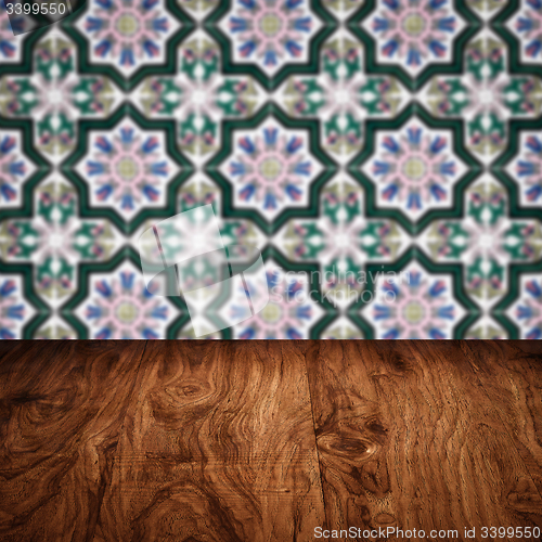 Image of Wood table top and blur vintage ceramic tile pattern wall