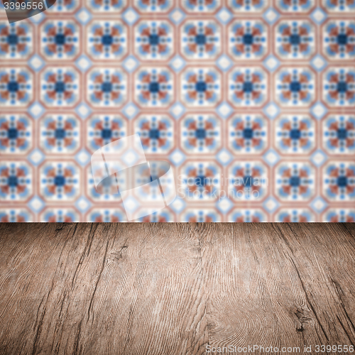 Image of Wood table top and blur vintage ceramic tile pattern wall